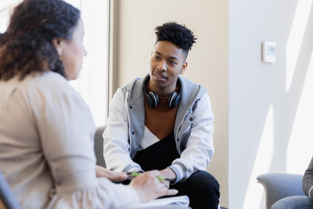counselor talks to the attentive young man