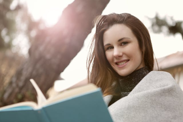 IV ketamine Woman looking at the camera while holding a book