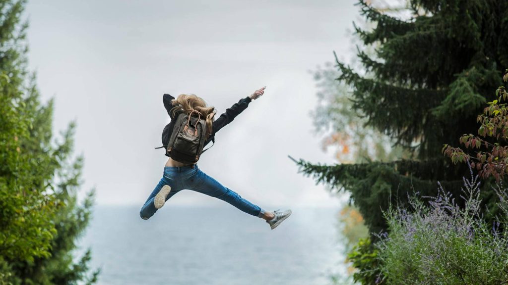Happy woman jumping with joy in a natural setting
