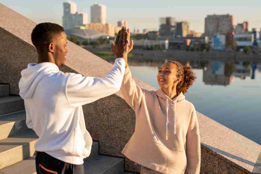 happy-young-female-and-african-sportsman