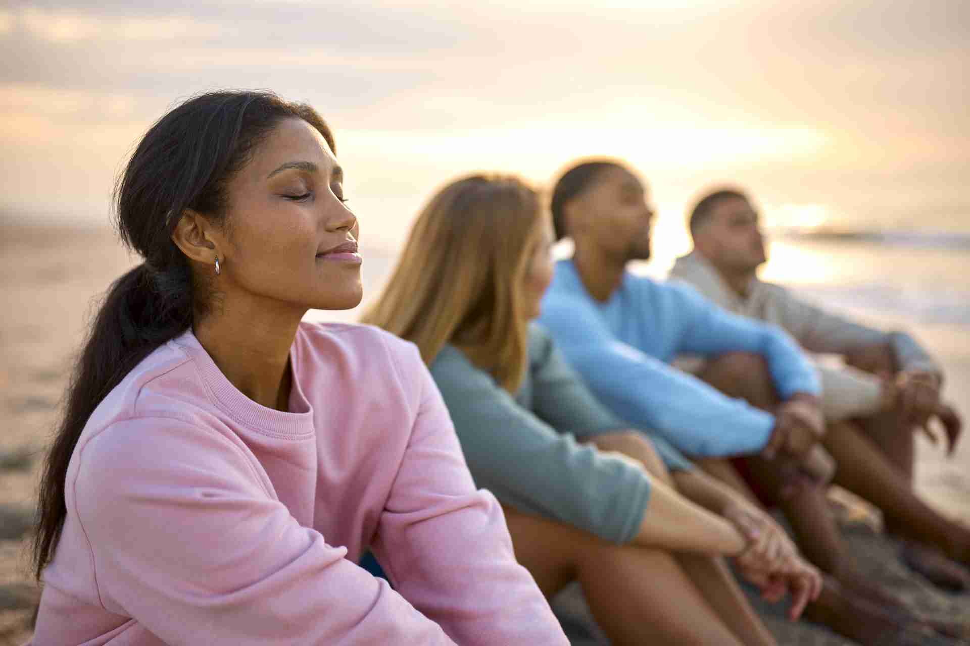 woman-with-closed-eyes-relaxing-with-friends